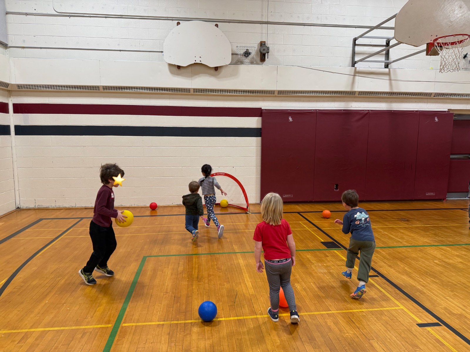 Kids playing a ball game in the gym during a movement program