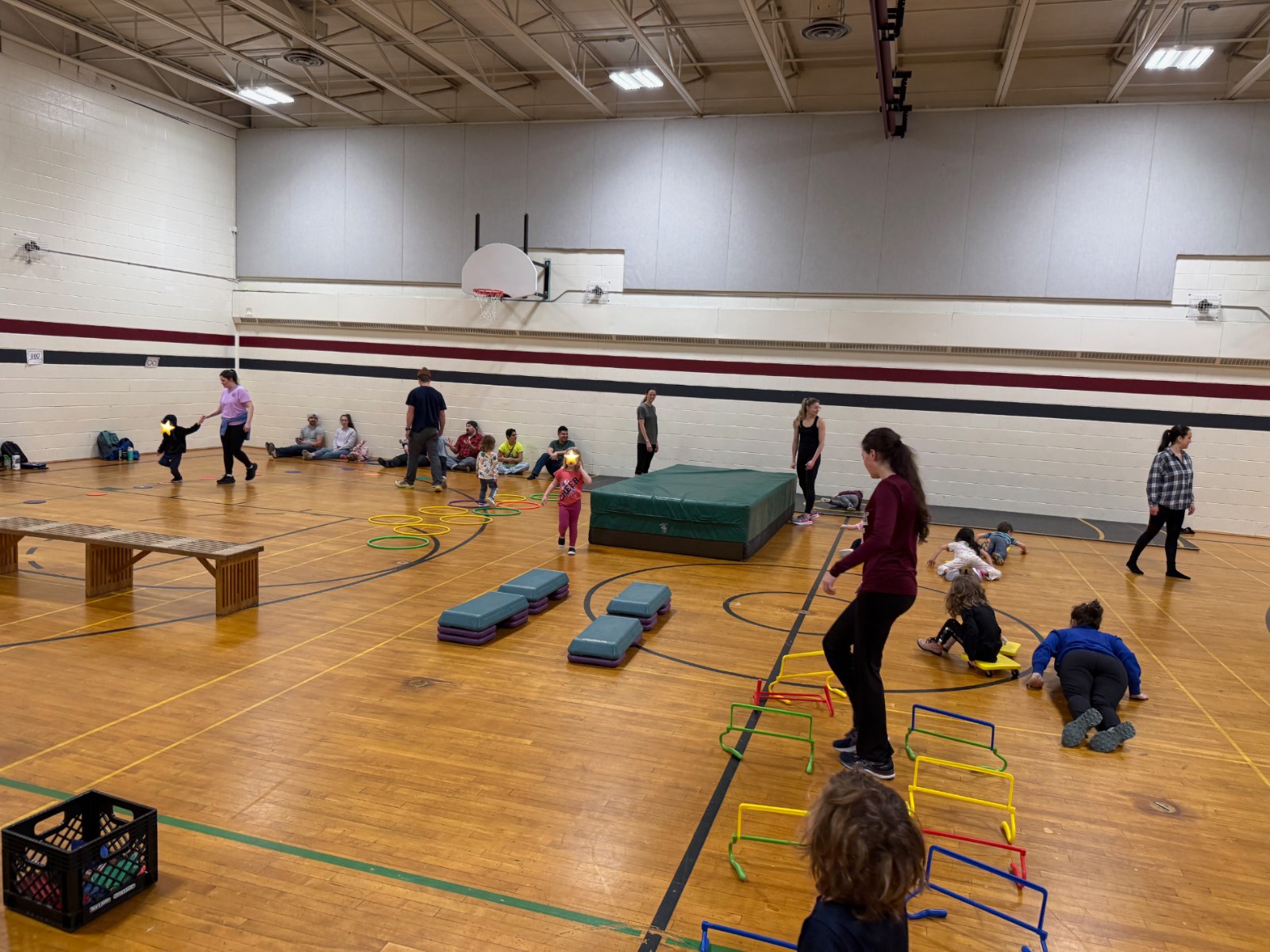 Kids working through an obstacle course with hurdles and balance steps