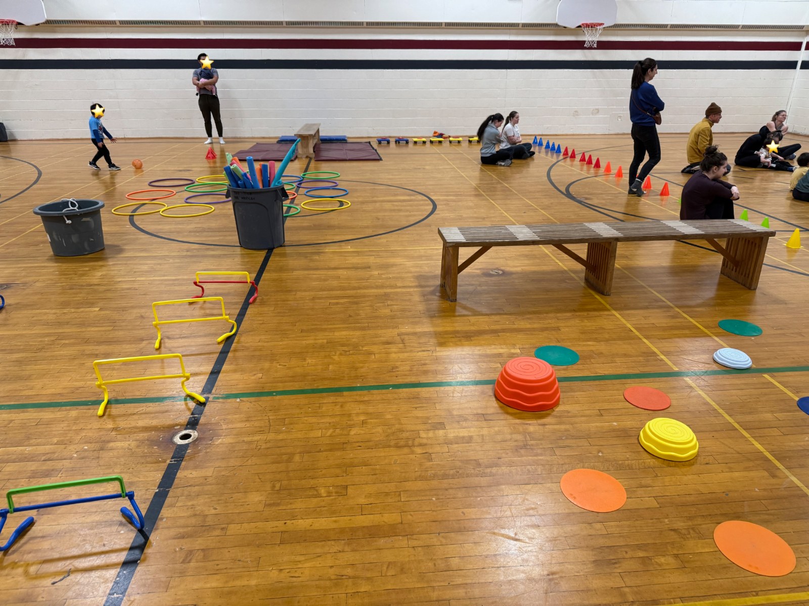 Gym set up with hurdles, cones, and agility equipment for a movement program